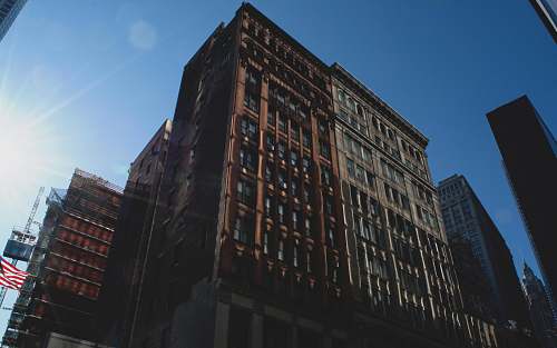 high rise low-angle photography of brown concrete building town